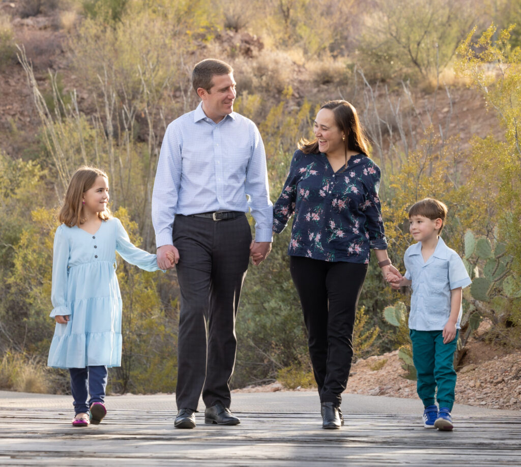 Family photo: Linda Bain walking hand in hand with her family on a desert path.